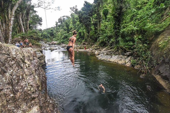 Hike El Yunque Rainforest and Kayak Bio Bay Combo Tour - Entering El Yunque: muddy trails, river-wading, and waterfall pool time